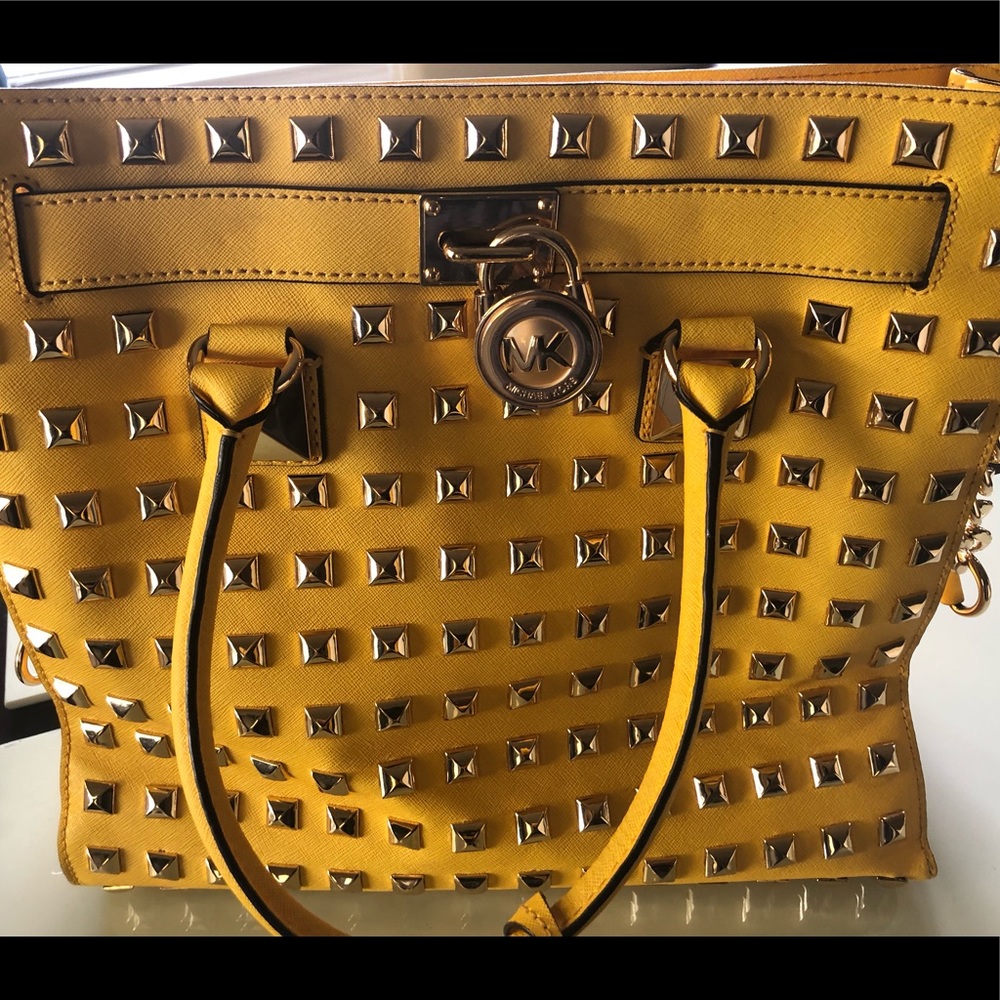 Studded gold Michael Kors leather handbag.